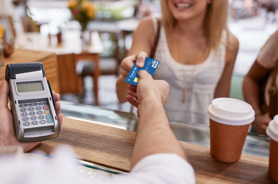 Handing back a Great Western Bank debit card after buying a coffee.