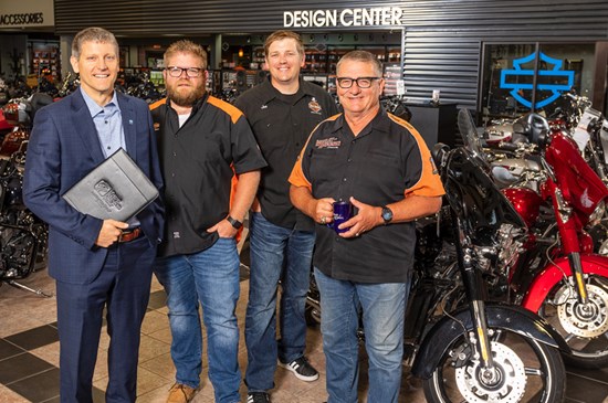 Great Western Bank business banker posing with leadership from J&L Harley in Sioux Falls, SD with motorcycles in background.