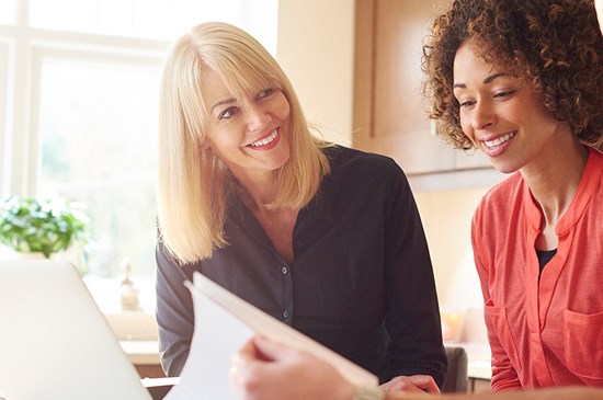 Stock photo of a mortgage loan officer meeting with a young couple