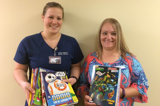 Displaying books the Lincoln Nebraska employees donated to the children's hospital