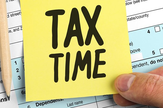 Stock image of a post it note with the words Tax Time on it