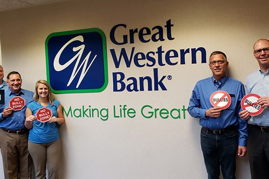 Great Western Bank employees holding anti-bullying signs in Omaha