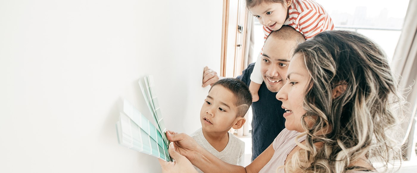 Stock image of a family picking out paint colors