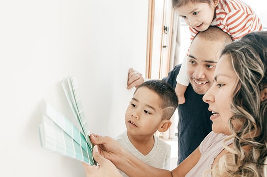 Stock image of a family picking out paint colors