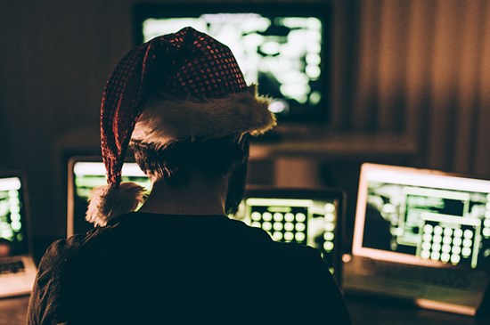 Stock image of a suspicious looking dark room with computer screens.