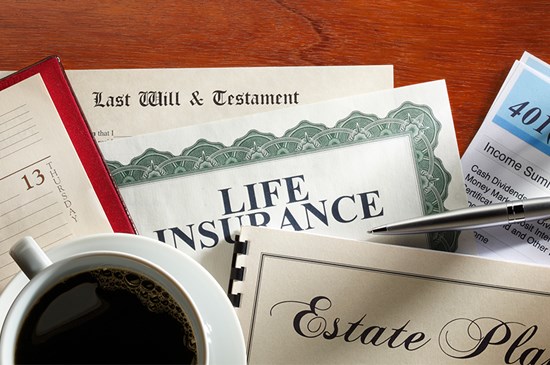Stock photo of financial documents that might be included within a Wealth Management plan. Includes a Will, Life Insurance, Estate Plan and 401(k) statement.